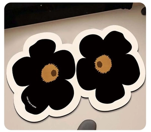 Detail of floral bath mat with HAVE A NICE DAY text on a soft absorbent fabric surface
