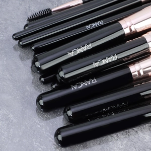 Macro detail of professional black and rose gold makeup brushes with RANCAI logo engraving