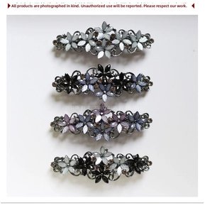 Detailed set of four vintage floral hair clips with rhinestones and alloy bases
