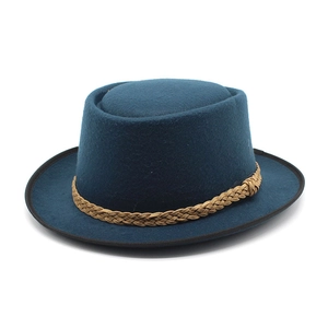 Detail of navy wool felt hat with brown braided band and black piped edge trim