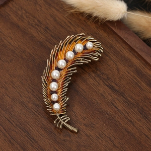 Vintage gold peacock feather brooch with sparkling zircon and elegant white pearls