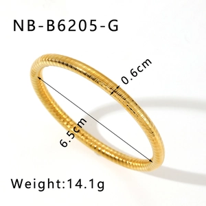 Detail view of gold stainless steel ribbed bangle with 6.5cm inner diameter and 0.6cm width