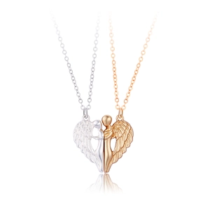 Detailed view of angel wing couple necklaces forming a heart with gold and silver finishes