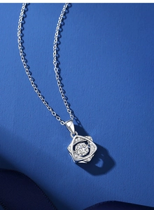 Macro detail of S925 sterling silver hexagram necklace with moissanite on blue background