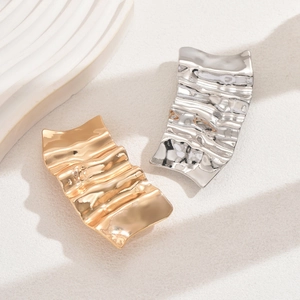Irregular liquid metal hair clips in gold and silver finish with wavy texture