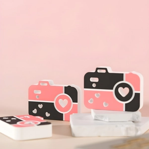 Macro detail of camera-shaped silicone mold with heart lens on a decorative stone