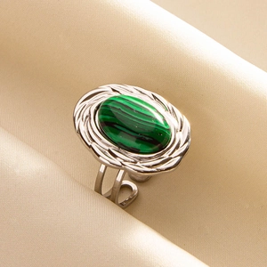 Macro detail of oval malachite stone on adjustable silver-tone rope textured ring