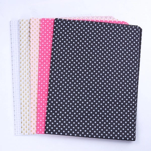 Multiple colors of polka dot tissue paper sheets stacked for flower bouquet packaging