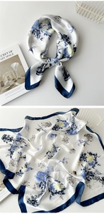 Close-up of blue and white floral silk scarf with elegant porcelain pattern and smooth texture