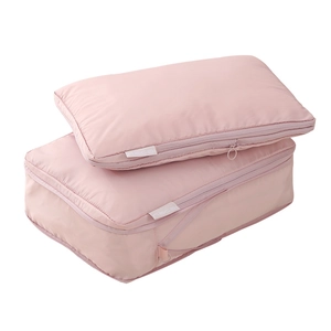 Pink waterproof travel organizer set with two packing cubes and side handles for luggage