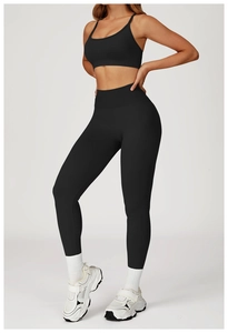 Detail view of seamless black yoga bra and high waist leggings for fitness workout wear