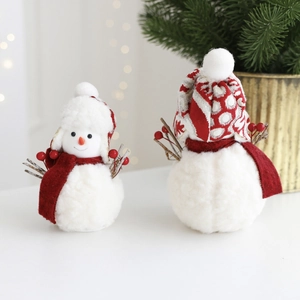 Close-up of plush Christmas snowman set with red hats and scarves on festive background