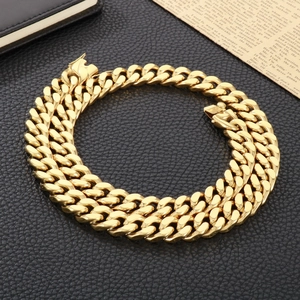 Detailed macro view of a 13mm gold stainless steel Cuban link chain for men on leather