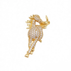 Exquisite gold-plated Pegasus brooch with sparkling cubic zirconia on a white background