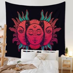 Detail of bohemian wall tapestry with sun and moon motifs in a cozy bedroom setting