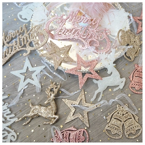 Close-up of sparkling Christmas ornaments set with Merry Christmas text stars and reindeers