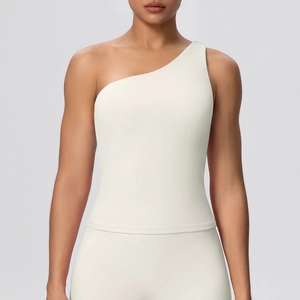 Detail of creamy white high-elasticity yoga top showing fabric texture and shoulder strap
