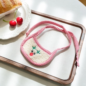 Detailed close-up of a festive Christmas reindeer pet bib in soft beige wool fabric