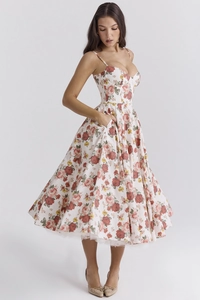 Close-up of floral summer dress with thin straps, sweetheart neckline and side pockets
