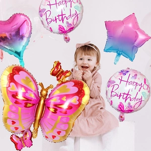 Close-up of vibrant butterfly, heart, and star foil balloons for birthday party decor