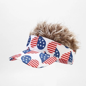 Close-up of white sun visor featuring a patriotic US flag heart and brown curly wig