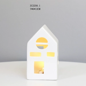 Detail view of white ceramic house LED night light with 7x6x12CM dimensions and window cutouts