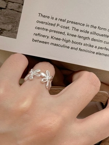 Detailed close-up of a sterling silver daisy ring on hand with elegant floral petals