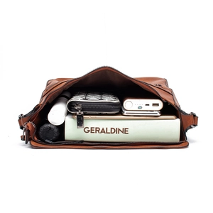 Top view of spacious caramel brown tote bag interior with books and daily essentials