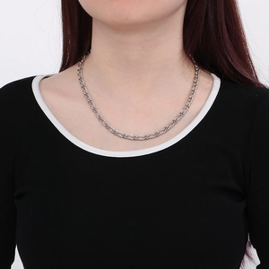 Silver stainless steel 3:1 curb chain necklace worn by a model on a white background