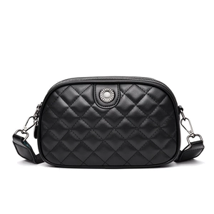 Black quilted crossbody bag with daisy metal detail and wide adjustable strap
