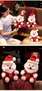 Close-up of soft plush Santa Claus doll with long white beard and cozy red fabric detail