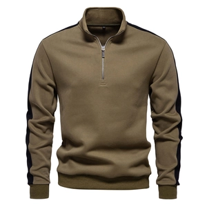 Detail of army green sweatshirt with half-zip collar and black striped sleeve contrast