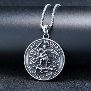 Detailed relief of Saint Michael on silver pendant with Saint Michael Protect Us engraving