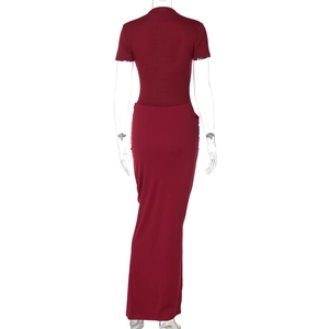 Detail view of the elegant deep red long dress with gathered waist and soft fabric texture
