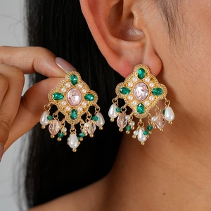 Vintage gold crystal drop earrings with pink stones and pearls on female model