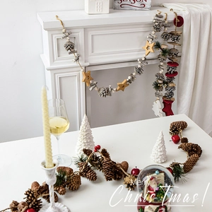 Rustic Christmas pine cone hanging decoration with wooden stars and red felt accents