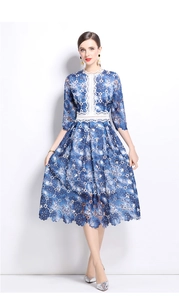 Detail of blue lace dress featuring white hollowed-out crochet trim and floral pattern