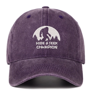 Close-up of white Bigfoot embroidery on a purple washed cotton vintage baseball cap