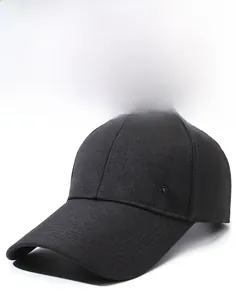 Detail of black baseball cap side with metal shield logo and breathable vent holes