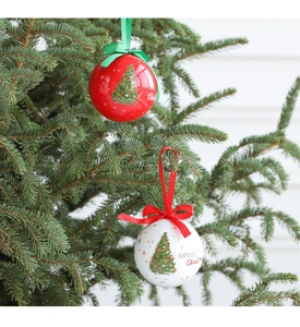 Detail of red and white foam Christmas balls with Merry Christmas text on a tree branch