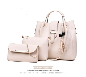 Three-piece beige handbag set featuring a large tote with bead tassel and ring handles