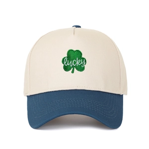 Detail of green leaf clover embroidery and white lucky script on cotton trucker cap