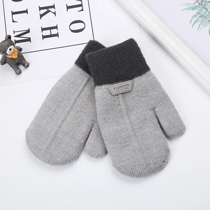 Detail of grey striped knit gloves with plush lining and leather fashion patch