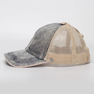 Detail view of washed denim baseball cap with breathable mesh back and reinforced stitching