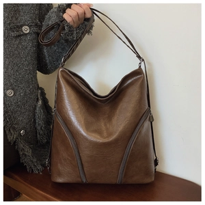 Detailed view of the dark brown faux leather texture on a retro large shoulder bag