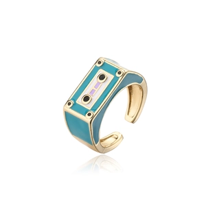 Macro shot of retro tape-shaped ring with teal enamel and adjustable gold band details