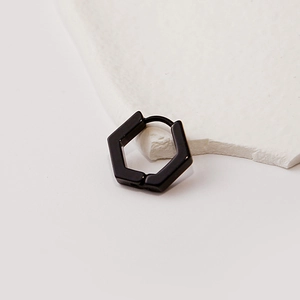 Minimalist black hexagonal hoop earring showcased on a white textured stone block