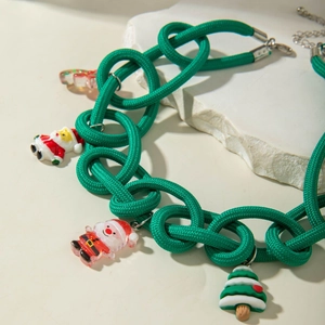 Detail of green lace choker necklace with festive Santa and Christmas tree resin charms