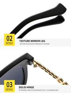Detail of sleek black sunglasses featuring gold chain-link metal solid hinges and textured legs