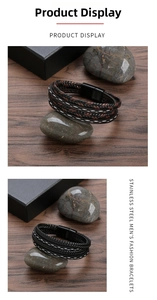 Detail of woven leather bracelets with black magnetic clasps on dark wood and stones